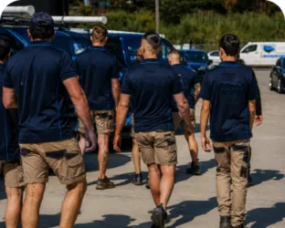 Plumbers walking to their service vans on a Burwood job